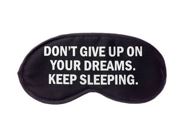 Black sleep mask with motivational quote on a white background