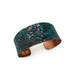 Copper bracelet with floral patterns on a white background