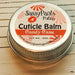 A cuticle balm  placed on a wooden surface.  Candy Cane.