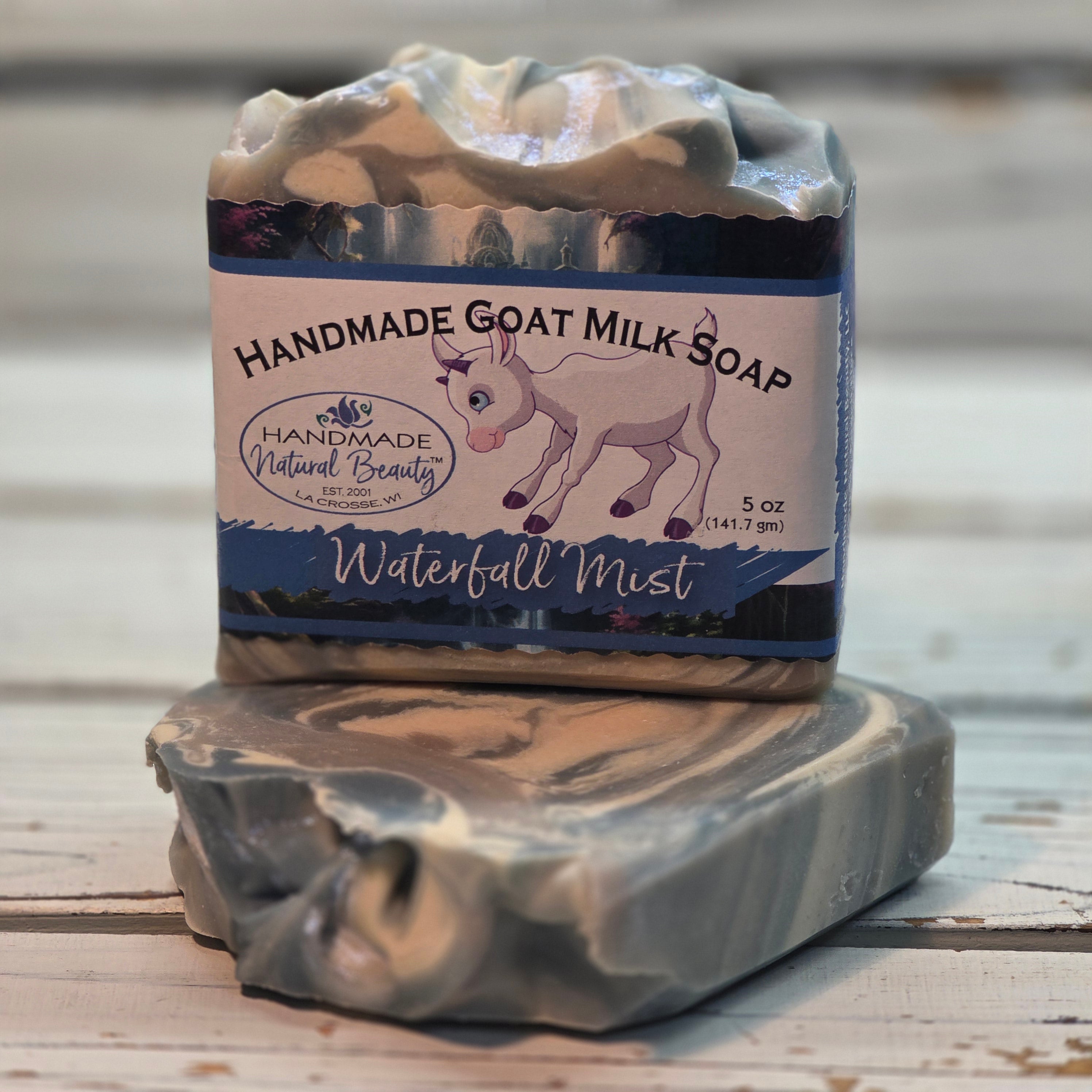 Handmade goat milk soap bar with a label by Handmade Natural Beauty on a wooden surface
