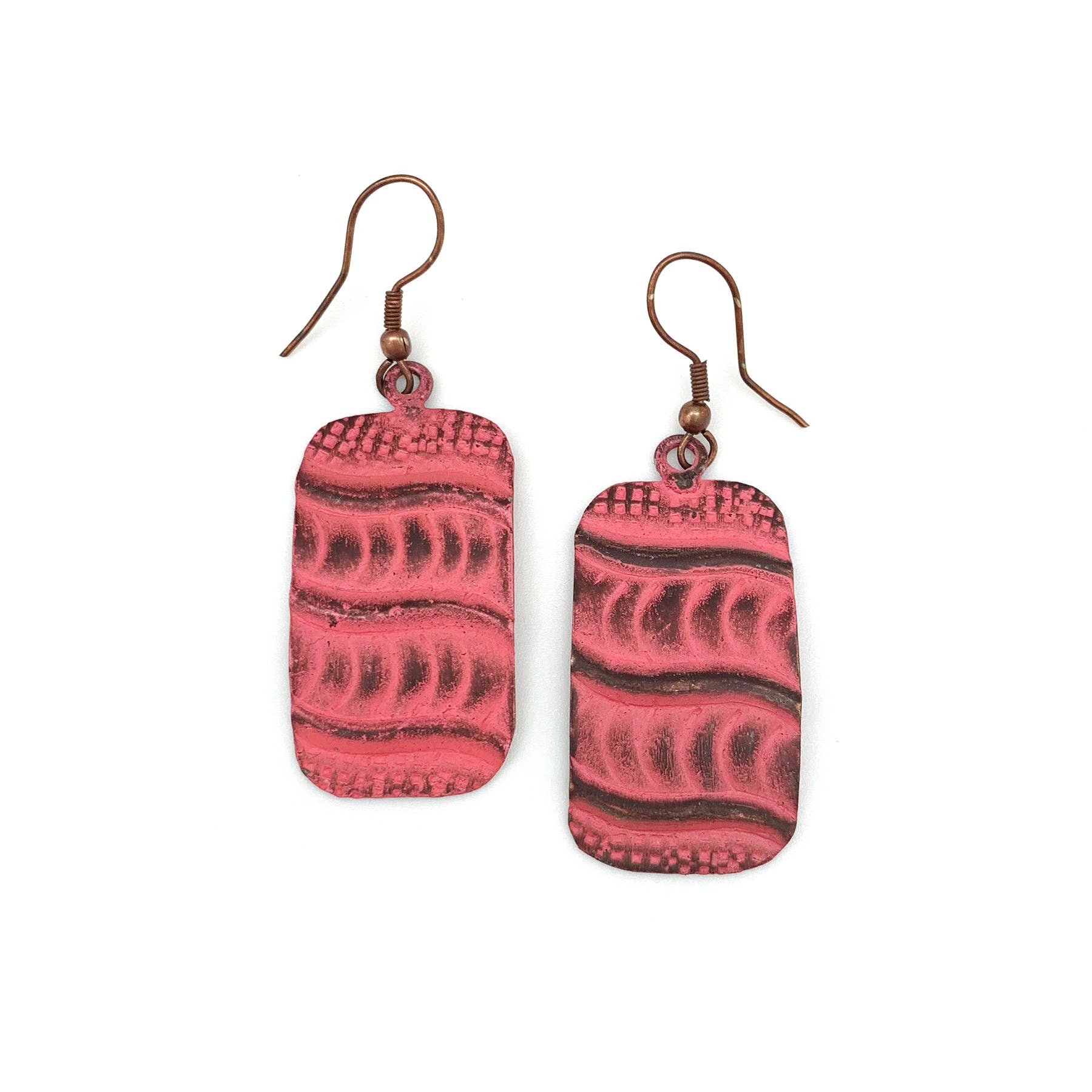 Pair of coral patterned  copper earrings on a white background