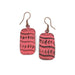 Pair of coral patterned  copper earrings on a white background