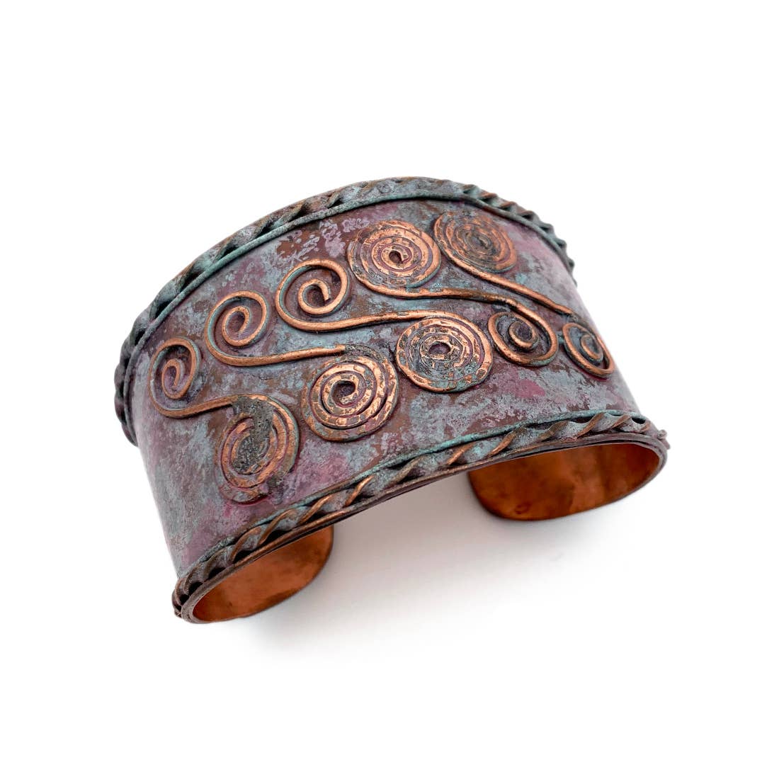 Copper cuff bracelet with intricate designs on a white background