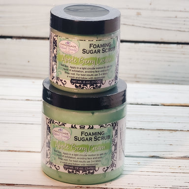 Two jars of Foaming Sugar Scrub with Apple Berry Cream on a wooden surface