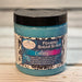 Jar of Galaxy foaming sugar scrub with decorative label by Handmade Natural Beauty on a wooden surface