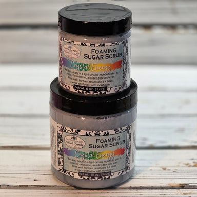 Crystal Energy Foaming sugar scrub containers with decorative label on a wooden surface