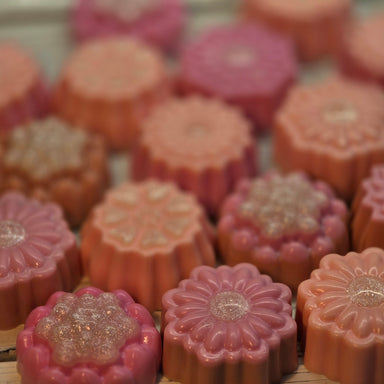 Assorted peach and pink flower shaped glycerin soaps by Handmade Natural Beauty.