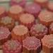 Assorted peach and pink flower shaped glycerin soaps by Handmade Natural Beauty.