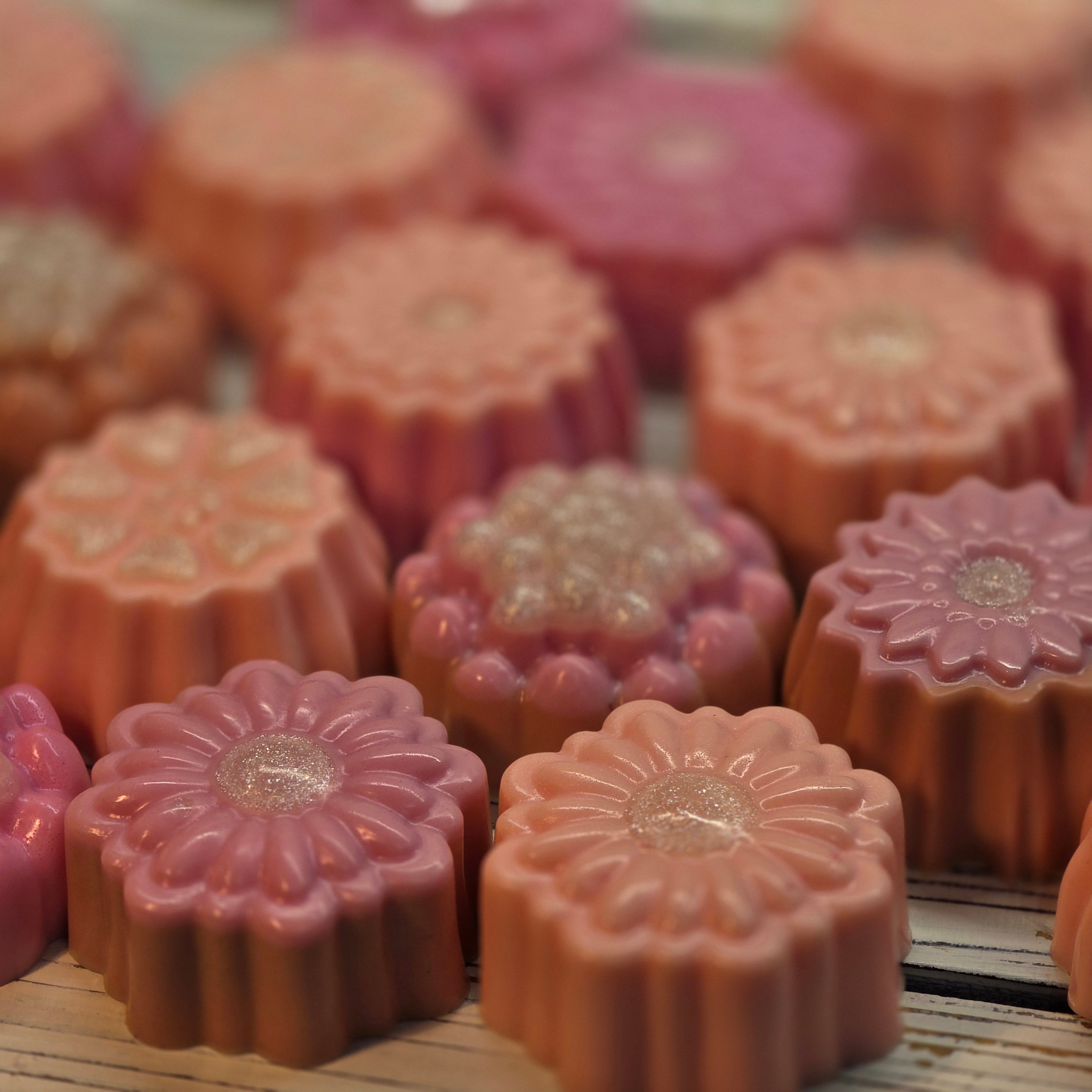 Assorted peach and pink flower shaped glycerin soaps by Handmade Natural Beauty.