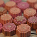 Assorted peach and pink flower shaped glycerin soaps by Handmade Natural Beauty.