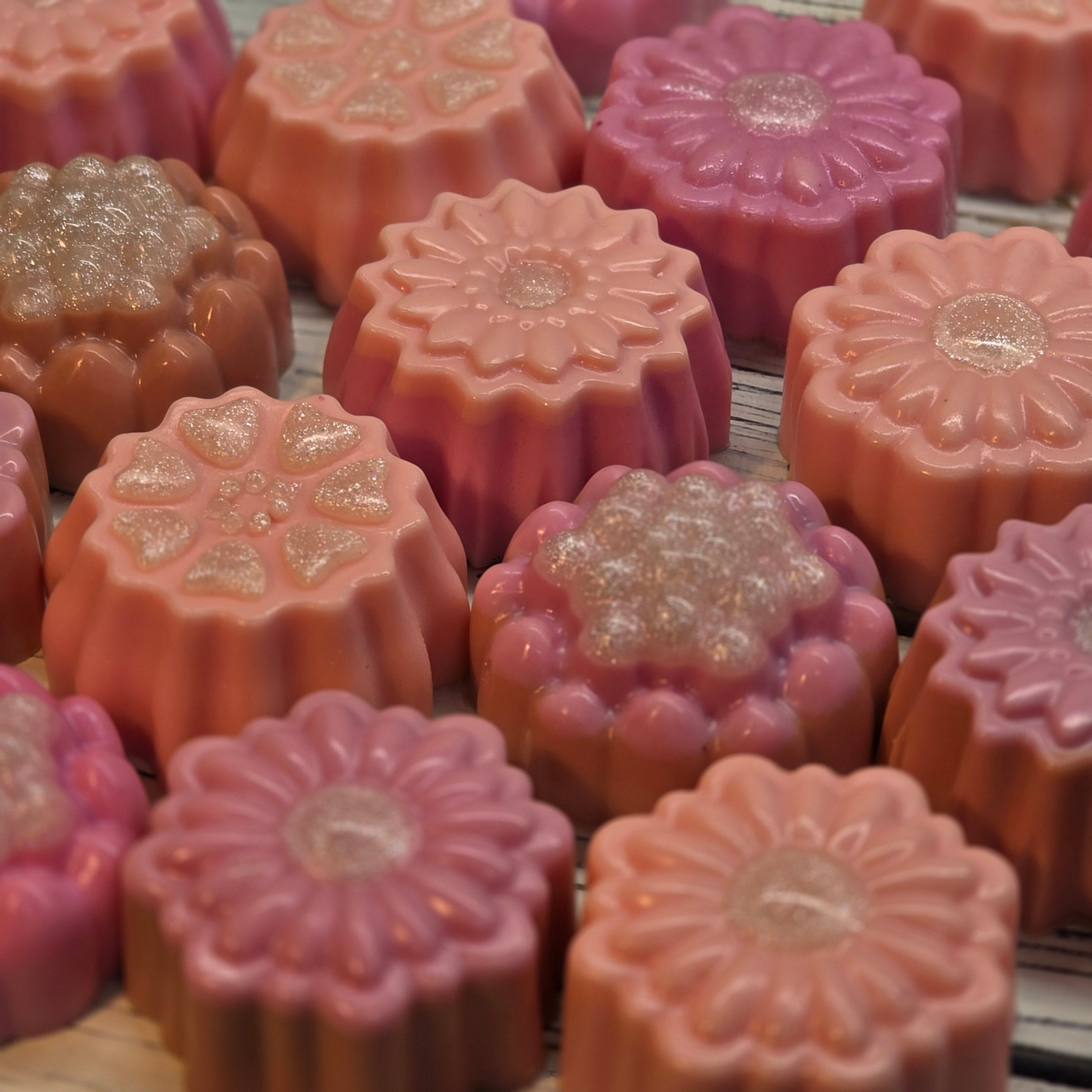 Assorted peach and pink flower shaped glycerin soaps by Handmade Natural Beauty.