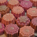Assorted peach and pink flower shaped glycerin soaps by Handmade Natural Beauty.