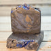 Black gray and blue swirled goat milk soap with glitter, sugar crystals and star bioglitter on top.