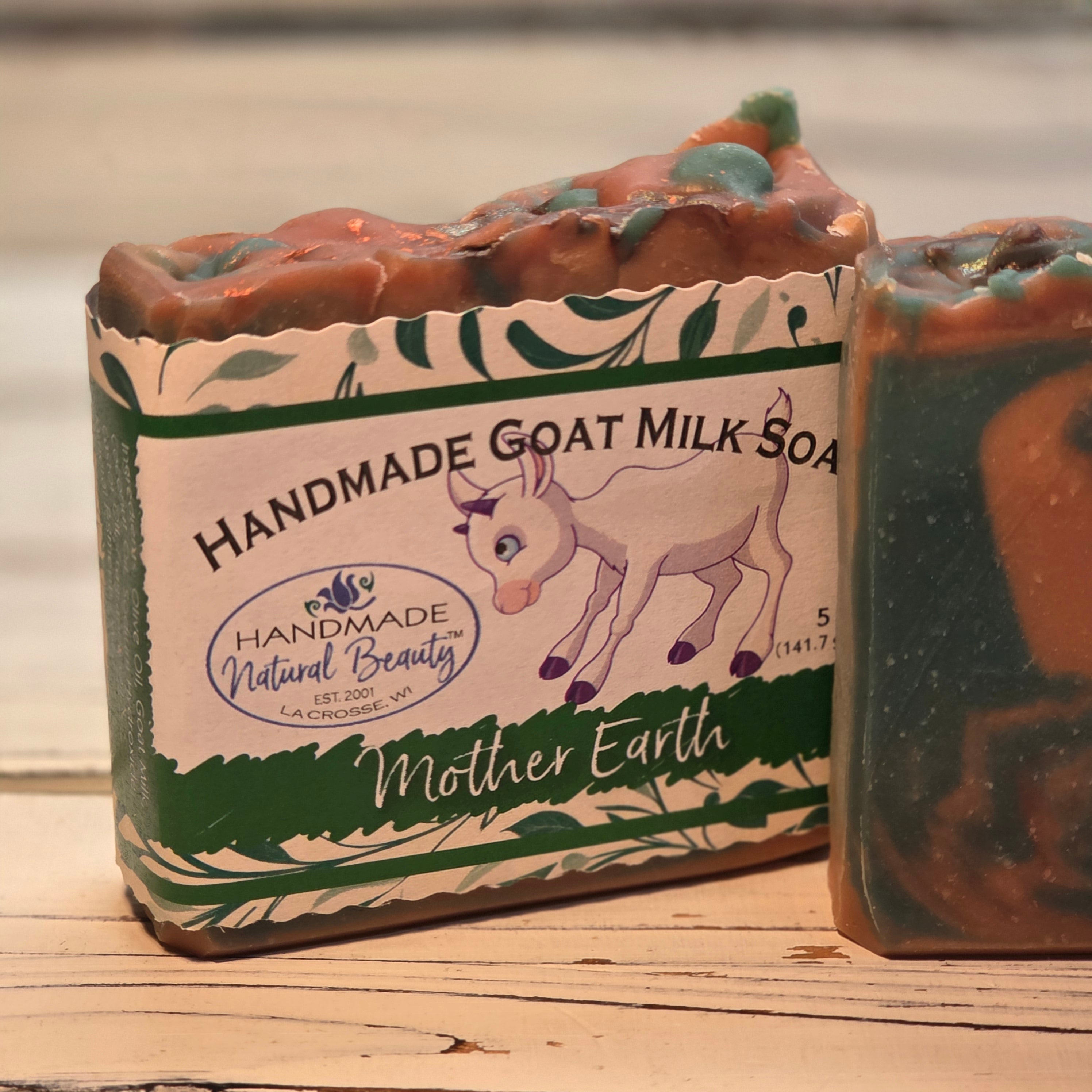 Bar of goat milk soap by Handmade Natural Beauty with 'Mother Earth' packaging on a wooden surface