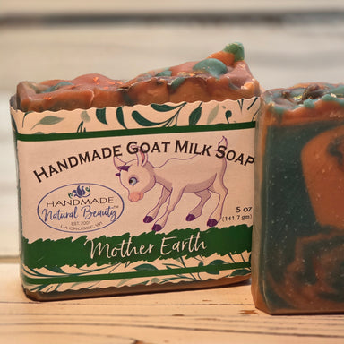 Bar of goat milk soap by Handmade Natural Beauty with 'Mother Earth' packaging on a wooden surface