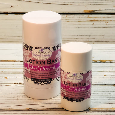 Two lotion bars with 'Velvet Orchid' label on a wooden surface