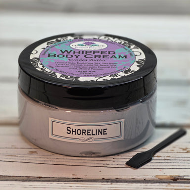 Jar of Shea butter whipped body cream in Shoreline scent with paddle.