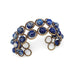 An adjustable wire-wrapped bracelet with lapis lazuli beads and antique brass clasps.