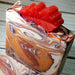 Orange purple and white swirled goat milk soap by Handmade Natural Beauty featuring an autumn leaf glycerin soap on top.